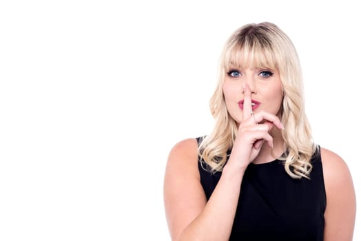 Attractive woman with finger on lips