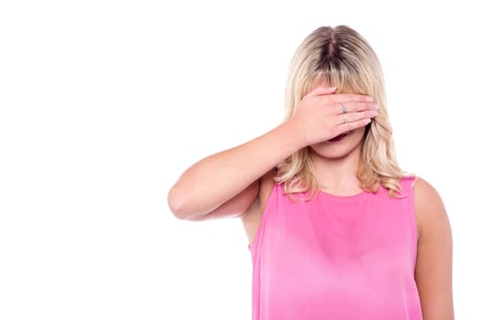 Woman covering her face with hand