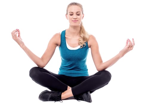 Beautiful woman meditating in lotus pose