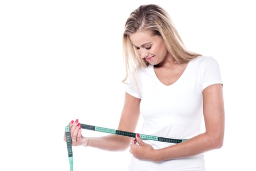 Pretty lady with an inch tape around her waist
