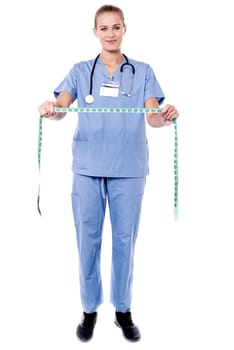 Young experienced doctor with measuring tape