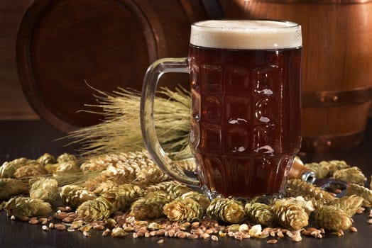 Beer glass with beer barrels,wheat,barley,hops and malt