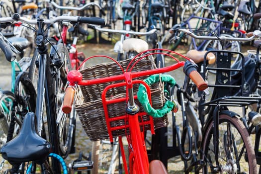red bicycle at a bicycle parking lot in a Dutch city