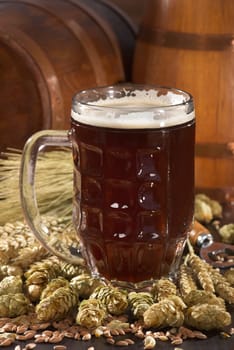 Beer glass with beer barrels,wheat,barley,hops and malt