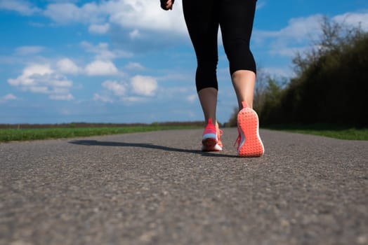 Jogger walks on a street in spring