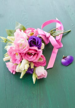 Fresh colorful Japanese rose on rustic background made of wood