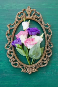 Fresh colorful Japanrose in vintage frameson Gruen
