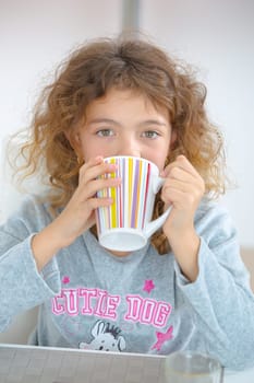 Little girl having a drink
