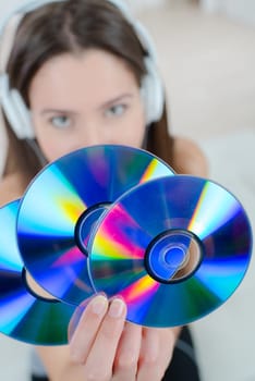 Woman holding a bunch of cds