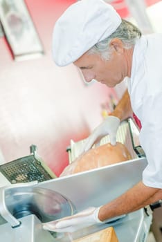 Butcher slicing ham