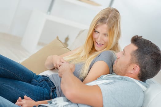 Playful couple fighting over the TV remote