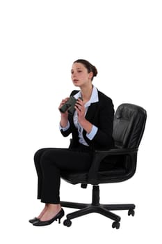 Businesswoman sat with binoculars