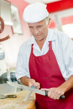 Butcher sharpening a knife