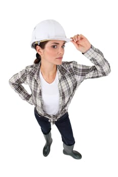 Female builder holding hat