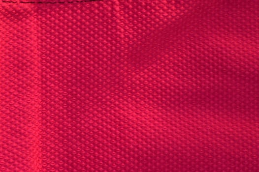 Vivid hot pink fabric background. Closeup of a textured pink fabric.