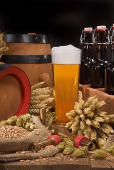 old beer carrier with beer glass,wheat,barley,hops and malt
