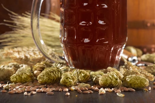 Beer glass with beer barrels,wheat,barley,hops and malt