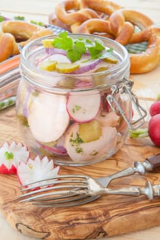 Typical Bavarian sausage salad in rustic mason jar