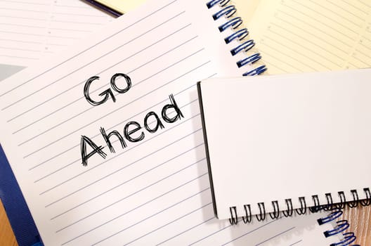 Go ahead text concept write on notebook