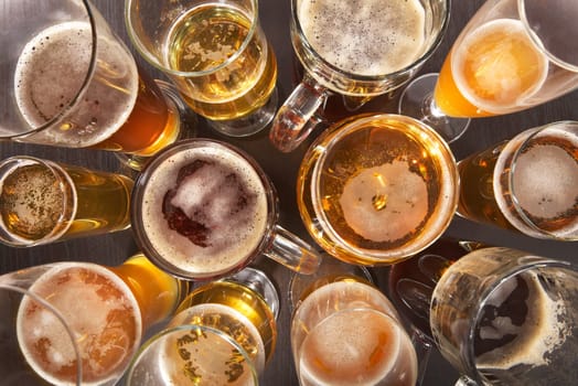 Many different beer glasses with different beer from all over the world