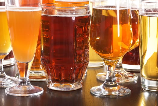 Many different beer glasses with different beer from all over the world