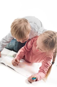 Little girl and boy painting. Shallow depth of field. Focus on the picture