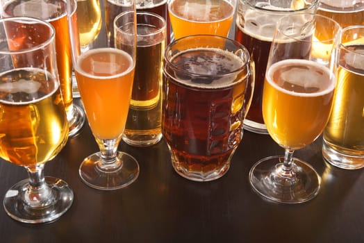 Many different beer glasses with different beer from all over the world
