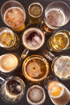 Many different beer glasses with different beer from all over the world