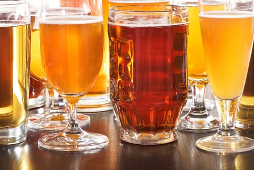 Many different beer glasses with different beer from all over the world