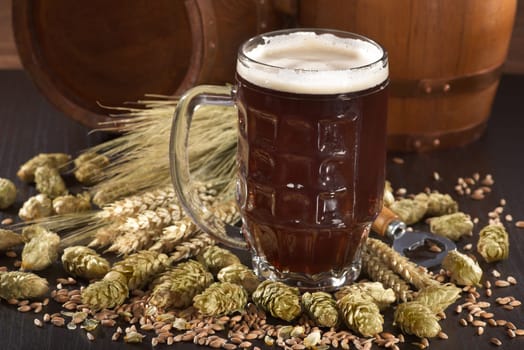 Beer glass with beer barrels,wheat,barley,hops and malt