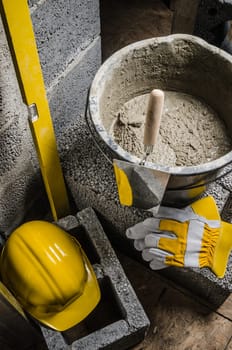 Tools for bricklayer bucket with a solution and a trowel, close-up