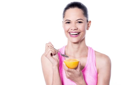 Smiling woman having an orange