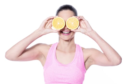 Young trainer putting sliced orange on eyes