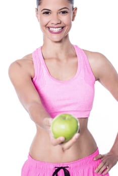 Slim fit woman giving green apple