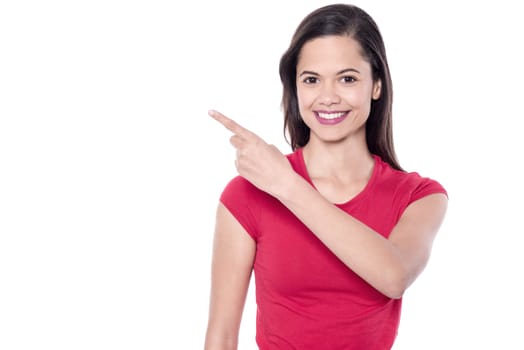 Casual young woman pointing to the side