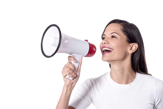 Pretty young woman yelling into a megaphone