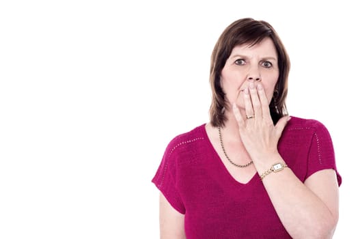 Picture of senior woman with hand over mouth