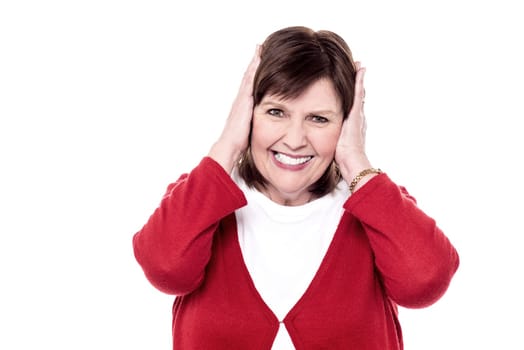 Senior woman shut her ears on white background