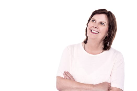 Senior woman folding arms and fond memories