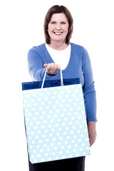 Happy elderly woman holding shopping bags