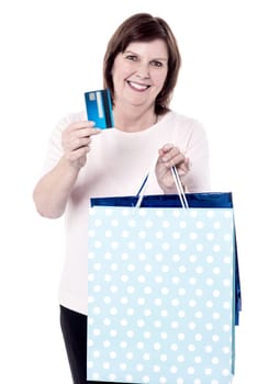 Happy senior woman paying for shopping by credit card