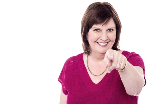 Cheerful senior woman pointing to you