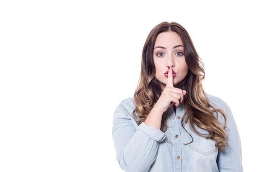 Portrait of pretty woman with finger on lips
