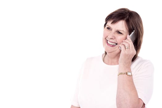 Happy senior woman talking in her mobile phone