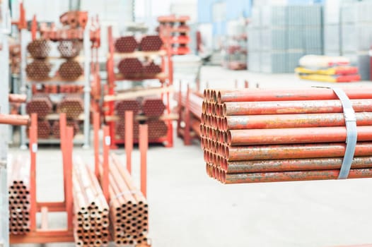 Stack of steel pipes for scaffolding in warehouse