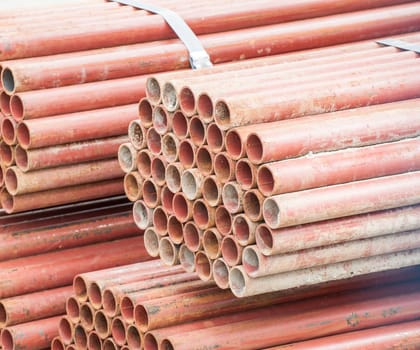 Stack of steel pipes for scaffolding in stock.