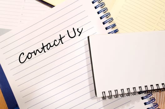 Contact us text concept write on notebook