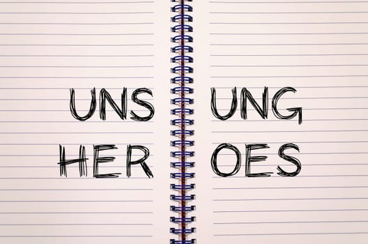 Unsung heroes text concept write on notebook