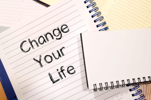 Change your life text concept write on notebook
