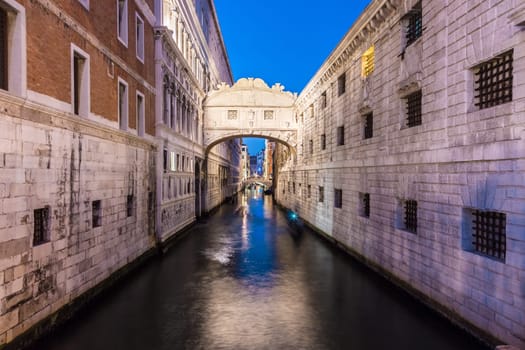 Gondolas passing under Bridge of Sighs, Ponte dei Sospiri. A legend says that lovers will be granted eternal love if they kiss on a gondola at sunset under the Bridge. Venice,Veneto, Italy, Europe.